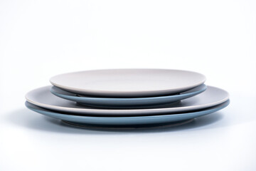 Stack of Dish Sets - Navy Blue and Grey plates isolated on white background side view, selective focus