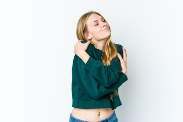 Young blonde woman isolated on white background hugs, smiling carefree and happy.