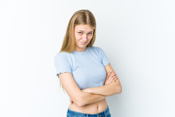 Young blonde woman isolated on white background frowning face in displeasure, keeps arms folded.