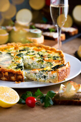 Shrimp, salmon , broccoli and spinach pie for Christmas celebration with bokeh lights. Delicious home made tart for family dinner or New year party