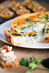 Shrimp, salmon , broccoli and spinach pie for Christmas celebration with bokeh lights. Delicious home made tart for family dinner or New year party