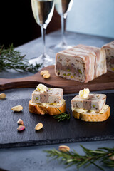 Christmas tapas with terrine on bread toast with butter,  New year celebration with white wine, delicious snack for party dinner