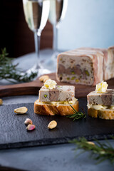 Christmas tapas with terrine on bread toast with butter,  New year celebration with white wine, delicious snack for party dinner