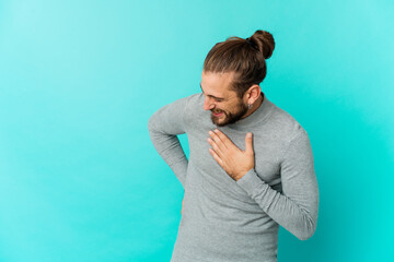 Young man with long hair look laughing keeping hands on heart, concept of happiness.