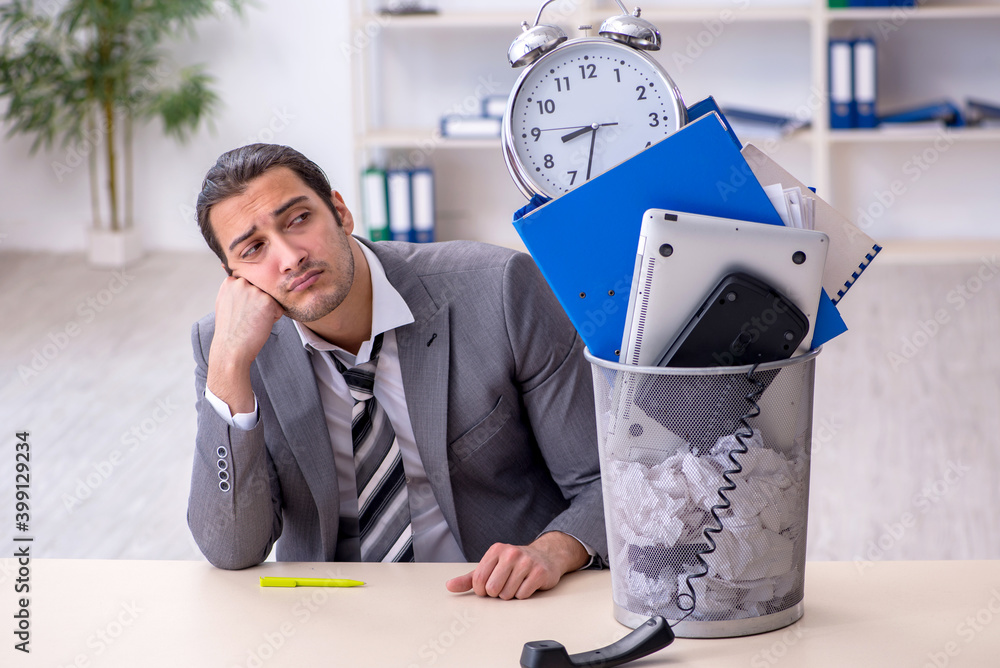 Wall mural fired young businessman with recycle bin in time management conc