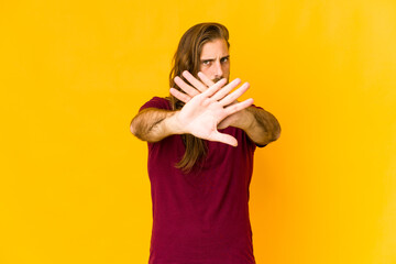 Young man with long hair look doing a denial gesture