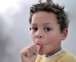 boy sucking thumb on white background stock photo