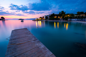 wooden pier with sea during dusk with sunset sky