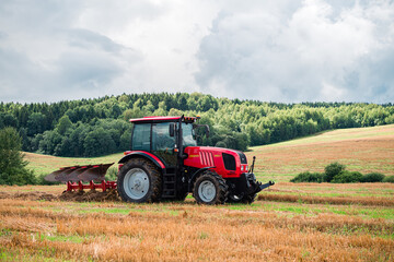 Fototapeta premium tractor plows the land