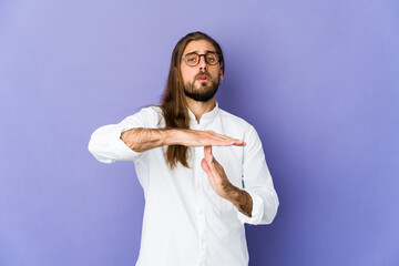 Young man with long hair look showing a timeout gesture.
