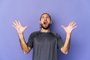 Young man with long hair look having fun covering half of face with palm. © Asier