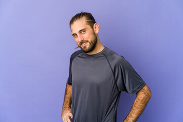 Young man with long hair look feeling energetic and comfortable, rubbing hands confident. © Asier