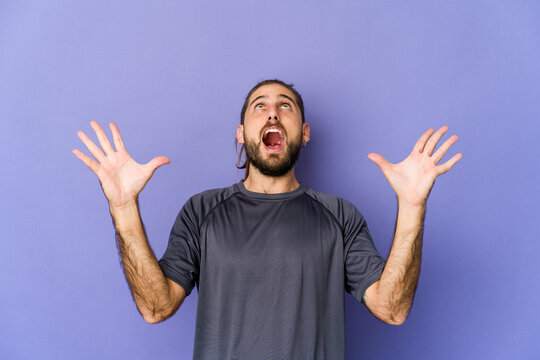 Young man with long hair look having fun covering half of face with palm.