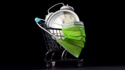 Antique clock in a shopping cart with a wearing green medical protective mask on a black background. Black Friday and Virus Countdown concept. Close up - Powered by Adobe