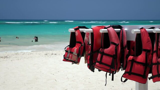 Life safety jackets on tropical beach. Lifejackets for water sport activity