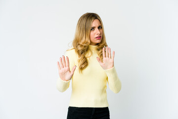 Young caucasian blonde woman rejecting someone showing a gesture of disgust.