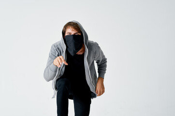 male thief in hood hidden mask tiptoe isolated fund