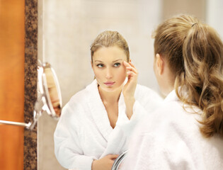 Magic anti-aging cream.Applying the cream. woman moisturizing face mask. Cosmetology and skin care...