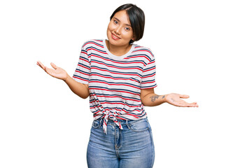 Beautiful young woman with short hair wearing casual clothes clueless and confused expression with...
