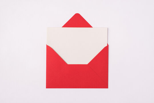 Photo of red open unwrapped envelope  with empty letter inside isolated white background