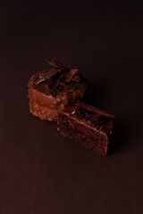 Stack of chocolate brownies chocolate cake on a brown background