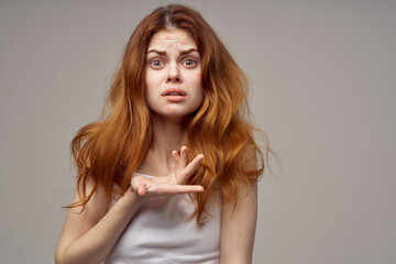 woman with loose hair acne on her face acne gesturing with her hands