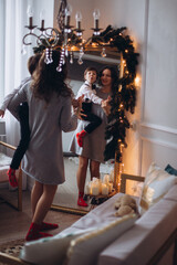 Mother and son together at christmas home with lights and eve. Motherhood, family, christmas  concept
