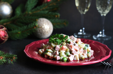 Traditional New Year's salad Olivier. New Year's festive table and glasses of champagne.