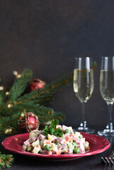 Traditional New Year's salad Olivier. New Year's festive table and glasses of champagne.