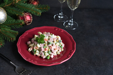 Traditional New Year's salad Olivier. New Year's festive table and glasses of champagne.