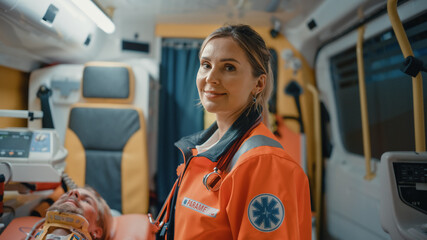 Calm and Happy Female EMS Professional Paramedic Smiles on Camera in Ambulance Vehicle. Successful...