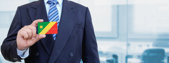 Cropped image of businessman holding plastic credit card with printed flag of Republic of the...