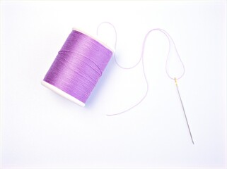sewing thread and needle ,Sewing spool of thread and scissors isolated on white background	