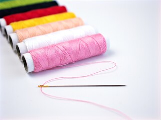 sewing thread and needle ,Sewing spool of thread and scissors isolated on white background	