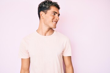 Obraz premium Young handsome man wearing casual clothes looking to side, relax profile pose with natural face and confident smile.