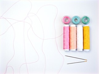 sewing thread and needle ,Sewing spool of thread and scissors isolated on white background	