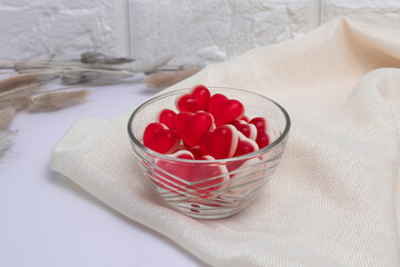 Gelatin hearts in a glass transparent saucer on a white background. Valentine's day concept.