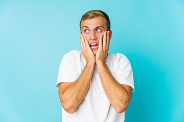 Young caucasian handsome man scared and afraid.