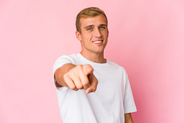 Young caucasian handsome man pointing to front with fingers.
