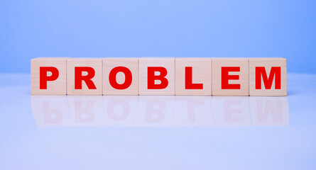 The word problem made from wooden cubes on a blue background.