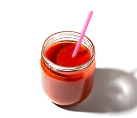 jar of tomato juice with a straw on a white background. healthy food concept.