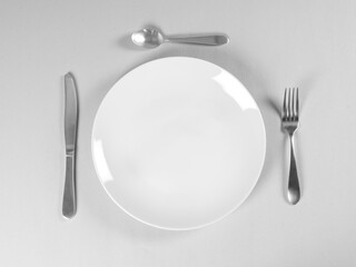 Plate isolated with cutlery on background.