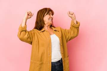 Senior caucasian woman isolated celebrating a special day, jumps and raise arms with energy.