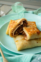 Sweet crepes filled with apple jam for breakfast