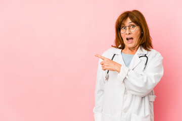 Fototapeta premium Middle age caucasian doctor woman isolated pointing to the side