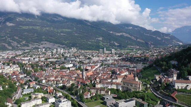 Aerial view of Chur townscape overlooking reformed church of St. Martin and Catholic Cathedral on summer day, canton of Graubunden, Switzerland. High quality 4k footage