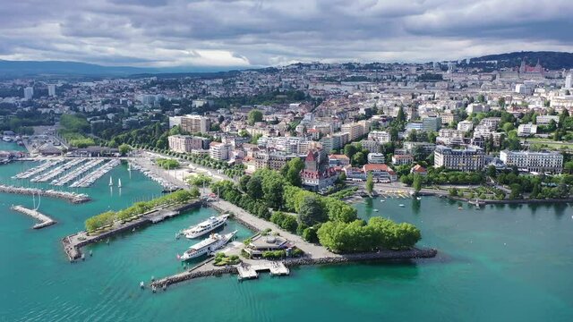 View from Lake Leman of residential areas of Swiss city of Lausanne in cloudy summer day, canton of Vaud in Romandy