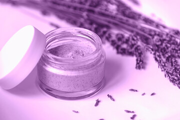 Obraz na płótnie Canvas Natural handmade cosmetic cream jar and dried lavender flowers, toned in purple. Bio organic cosmetics