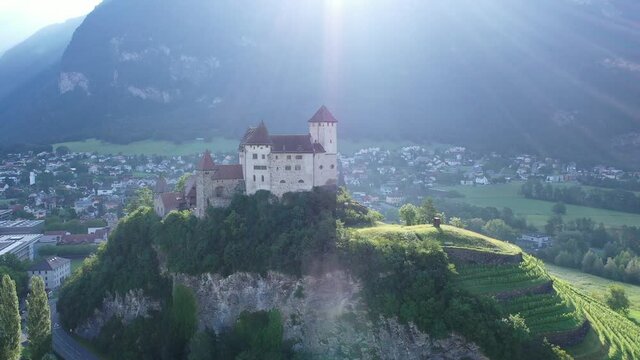 Scenic view of medieval Gutenberg Castle on hilltop between greenery on cloudy summer day, Balzers, Liechtenstein