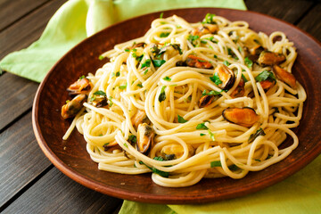 Italian spaghetti with shrimps and mussels on brown plate